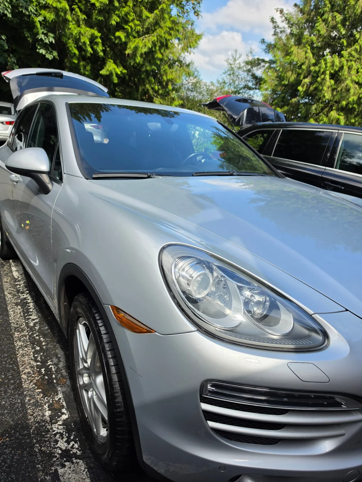 Silver Porsche Cayenne luxury SUV front quarter exterior after detailing